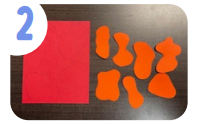 Labeled "two." A red sheet of paper has abstract shapes traced onto it in blue pen, and there are cut out abstract shapes in orange paper next to it.