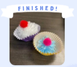 Labeled "Finished!" A photo of two completed handmade pom pom cupcakes.
