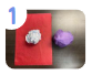 Labeled "one." A crumpled up ball of paper sitting on top of red tissue paper. Next to it, a crumpled up ball of paper is wrapped in purple tissue paper.