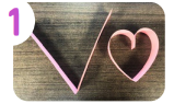 Labeled "one." A small strip of pink paper folded in half on the right, and a strip of pink paper formed into a heart of the left.