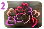 Labeled "two." Several paper hearts in red, pink, and purple.