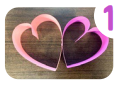 Labeled "one." Two paper hearts connected on their sides.