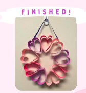 Labeled "Finished!" A photo of a completed Valentine's Wreath hanging on a wall. 