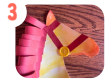 Labeled "three." A close up of a watercolor silhouette of a horse with red paper mane, red paper bridle, and one yellow button. 
