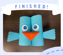 Labeled "Finished!" A photo of completed Birdnoculars, paper binoculars with eyes, a beak, and wings. 