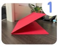 Labeled "one." A horizontally folded sheet of red cardstock sits on a desk. 