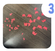 Labeled "3." On the right, there are several small three pointed crowns cut out of red construction paper. On the right, there are various small red triangles that were creating by cutting the crowns.