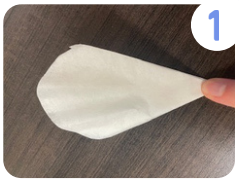 Labeled "one." A coffee filter folded into eighths that has been cut to resemble a flower petals.