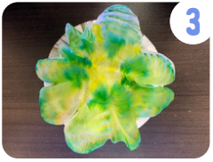 Labeled "3." A coffee filter sitting in a bowl has been dyed shades of green and yellow.